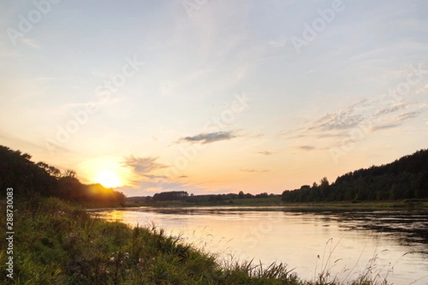 Fototapeta Sunset by the river in the summer countryside