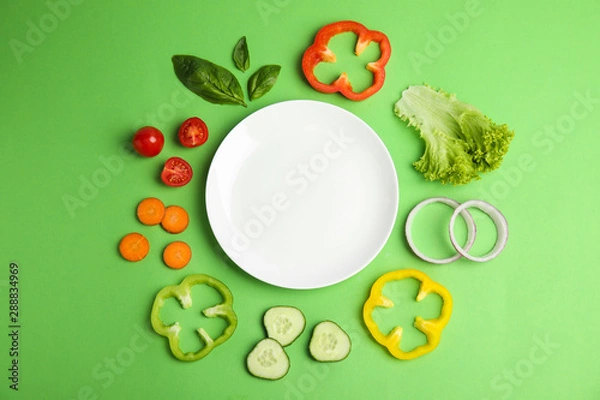 Fototapeta Flat lay composition with fresh salad ingredients on green background, space for text