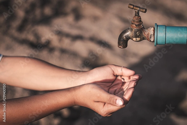 Fototapeta The little boy waiting for drinking water to live through this drought, Concept drought and crisis environment.