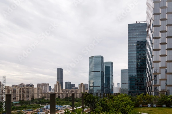 Fototapeta View of the construction of municipal residential buildings in the metropolis from the rooftop cafe