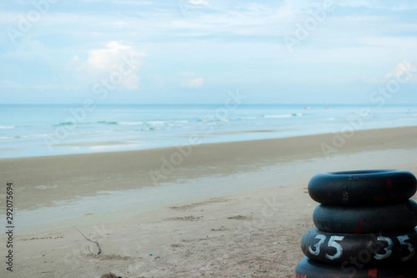 Fototapeta Lifebuoy made from car tires ,at the beach.