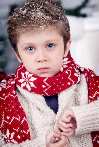 Fototapeta boy at Christmas by the fireplace and Christmas tree