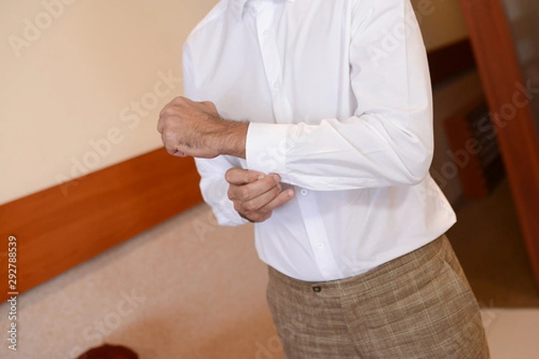 Fototapeta  Handsome businessman preparing for a meeting