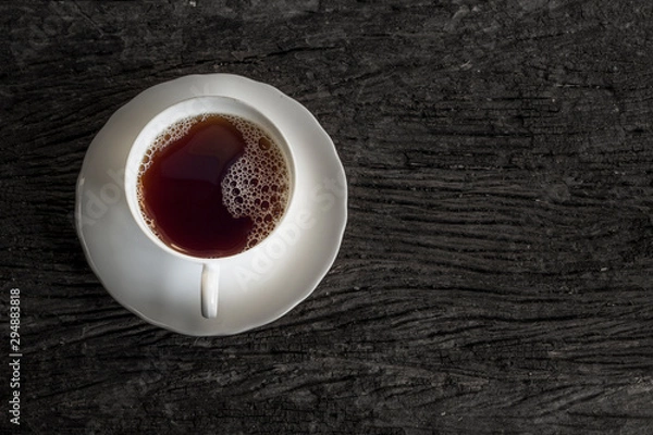 Fototapeta cup of coffee on a wooden plate on old wood 