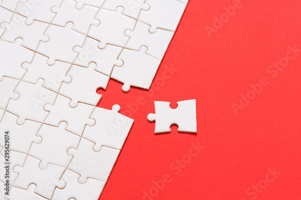 Obraz Business teamwork concept, Missing puzzle piece on red background. Search for the solution, solve the problem....