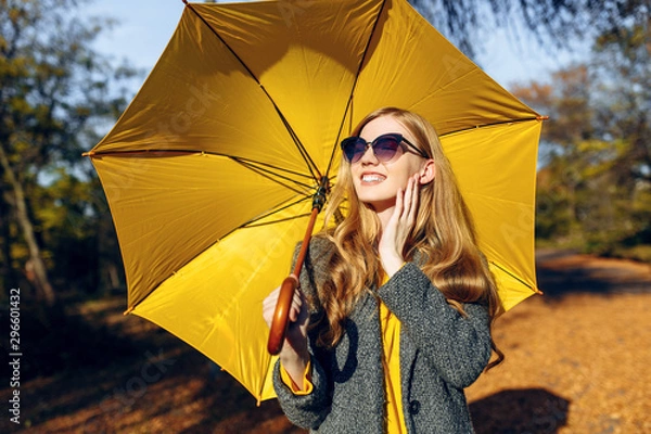 Obraz Girl, with yellow umbrella, in the Park with yellow leaves, autumn time