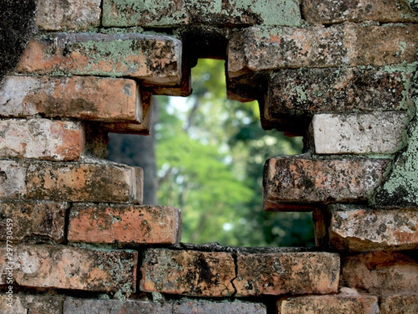 Fototapeta Hole in old wall brick of archaeological site at wat Si Chum temple, popular tourist attractions and famous landmarks in Sukhothai historical park, Sukhothai, Thailand. UNESCO world heritage city