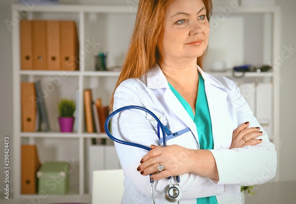 Fototapeta Portrait of happy medical doctor woman in office