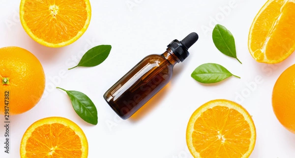 Fototapeta Essential oil with fresh orange citrus fruit with leaves isolated on white