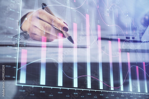 Obraz Double exposure of woman's hands making notes with forex graph hologram. Concept technical analysis.