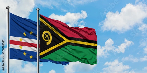 Fototapeta Cape Verde and Vanuatu flag waving in the wind against white cloudy blue sky together. Diplomacy concept, international relations.