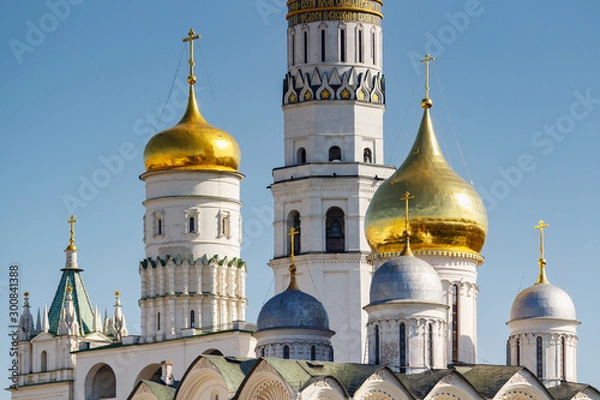 Fototapeta Domes of Cathedral of the Archangel close-up against Ivan the Great Bell-Tower on territory of Moscow Kremlin in sunny spring morning. Moscow Kremlin architecture