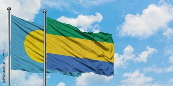 Fototapeta Palau and Gabon flag waving in the wind against white cloudy blue sky together. Diplomacy concept, international relations.