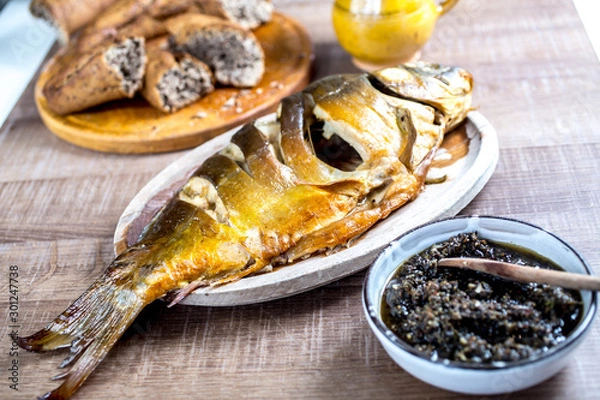 Fototapeta Grilled carp fish on vintage wooden table