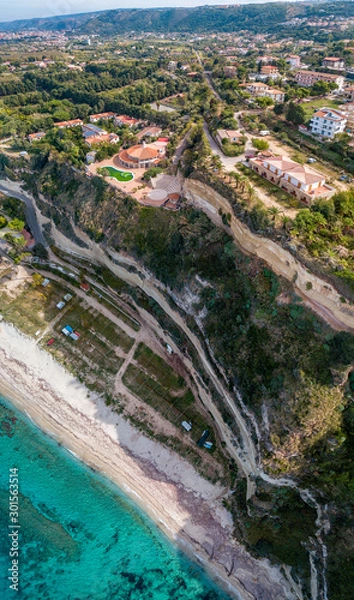 Fototapeta Aerial view of the Calabrian coast, villas and resorts on the cliff. Transparent sea and wild coast. Locality of Riaci near Tropea, Calabria. Italy