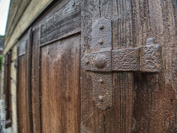 Fototapeta Outdoor view of part of ancient closed wooden shutters.