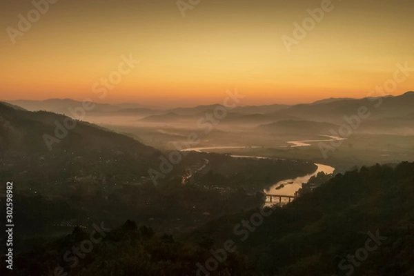 Fototapeta Mountain view morning above Kok river around with sea of mist, mountain and yellow light in the sky background, sunrise at Wat Tha Ton, Tha Ton, Fang, Chiang Mai, Thailand.