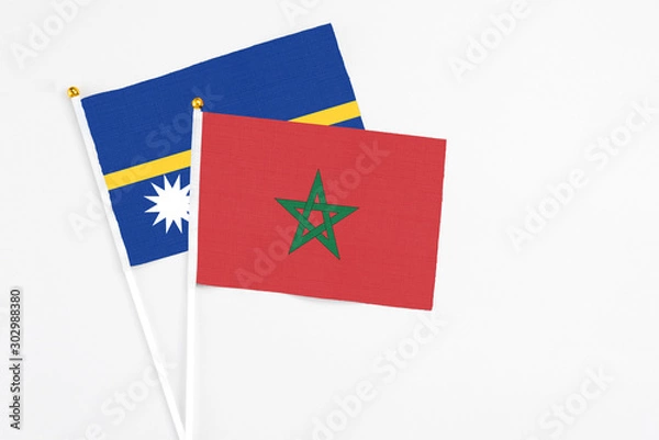 Fototapeta Morocco and Nauru stick flags on white background. High quality fabric, miniature national flag. Peaceful global concept.White floor for copy space.