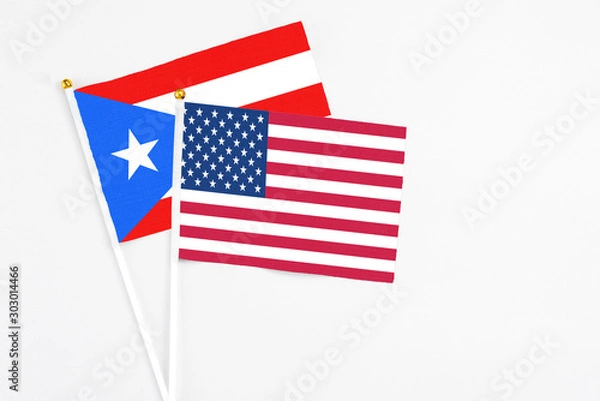 Fototapeta United States and Puerto Rico stick flags on white background. High quality fabric, miniature national flag. Peaceful global concept.White floor for copy space.