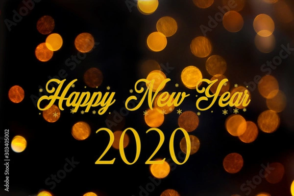 Obraz Happy new year 2020 in golden letters on a black background with golden lights