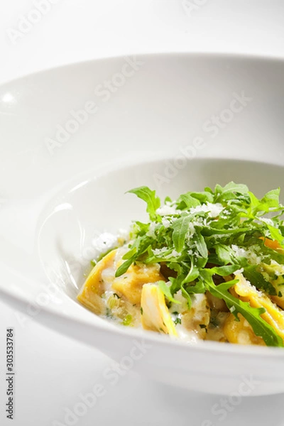 Fototapeta Tortellini with rabbit meat pesto sauce and arugula