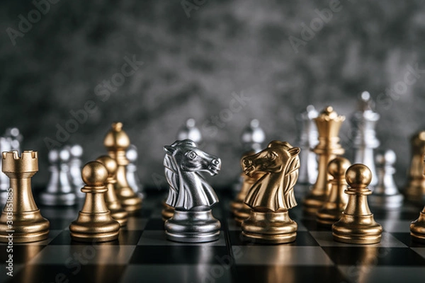 Fototapeta Gold and Silver Chess on chess board game for business metaphor leadership concept