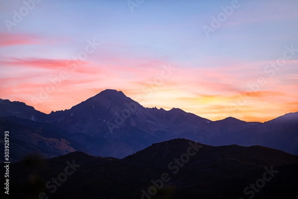 Fototapeta Aspen, Colorado colorful red blue pastel sunset twilight with Snowmass mountain peak ridge closeup dark silhouette