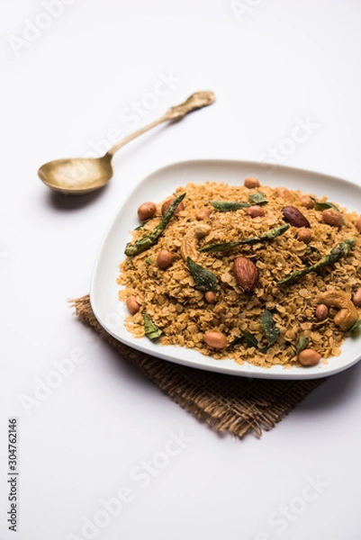 Fototapeta Oats Chivda / Chiwda is a healthy indian recipe with added chilli, peanuts, cashew, almond and curry leaf for flavour. Selective focus