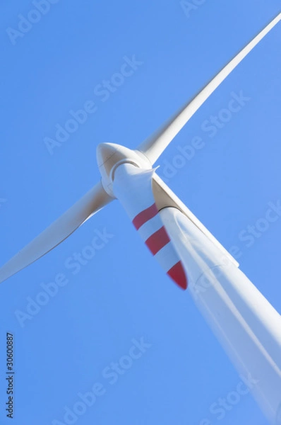 Fototapeta Wind turbine against blue sky