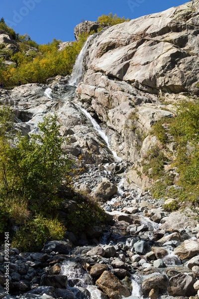 Fototapeta Dombay mountains, trekking in national park to the Alibek waterfall and glacier, autumn landscape