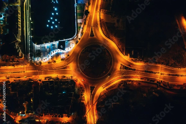 Fototapeta Night city traffic on circle intersection in Paphos, Cyprus. Aerial top down view from drone.