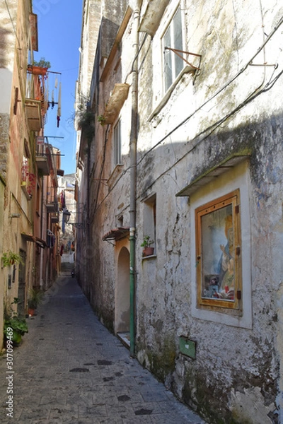 Fototapeta A small street among the old houses of Sessa Aurunca, a medieval village in the province of Caserta