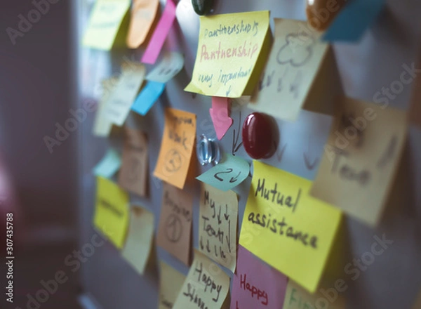 Fototapeta Sticky notes on the board for business memos and ideas.