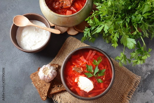 Fototapeta Traditional Ukrainian Russian borscht . Bowl of red beet root soup borsch with white cream . Beet Root delicious soup . Traditional Ukrain food cuisine 