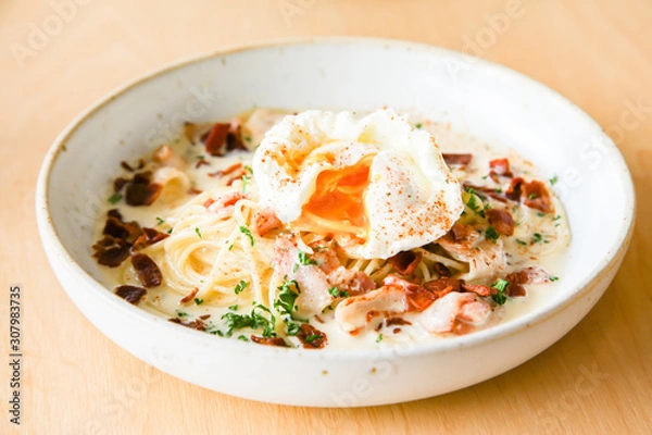 Fototapeta Pasta cream sauce with bacon and poached egg