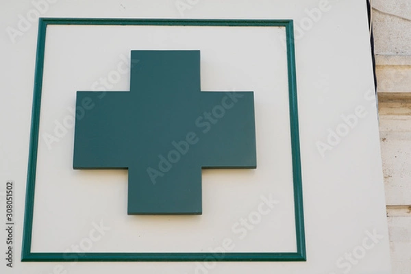 Fototapeta green cross Pharmacy sign in street