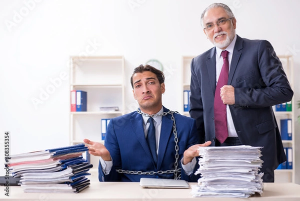 Fototapeta Old boss and young male employee in the office