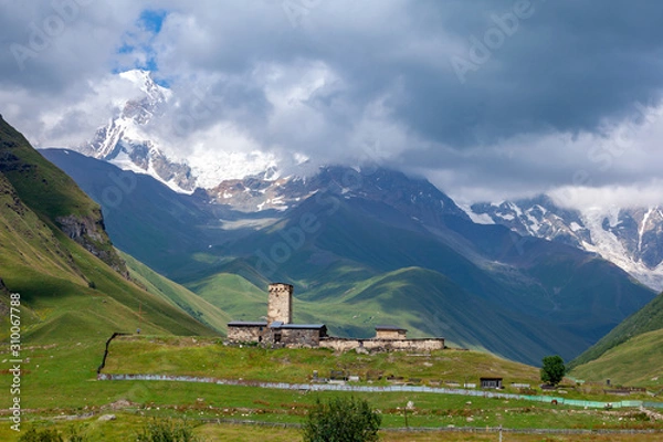 Fototapeta View of the Ushguli village at the foot of Mt. Shkhara. Lamaria Monastery, old Rock tower.