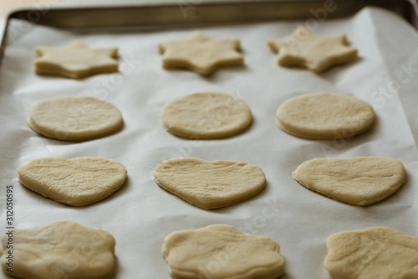 Fototapeta Homemade cookies on a tray ready to be baked.