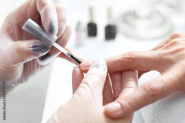 Fototapeta Painting nails, woman in a beauty salon.