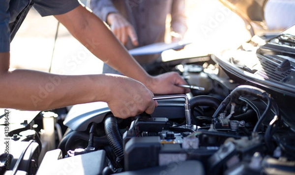 Fototapeta Car mechanic has checked the condition of the engine in wrench, Car repair service concept.