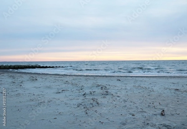 Fototapeta New England coastal sandy shoreline beach at sunset in winter