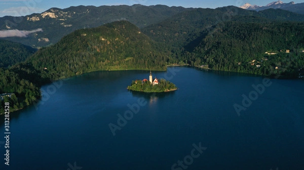 Fototapeta Aerial view of small island with Church of assumption of Mary in the middle of Lake Bled, Slovenia. Summer. Green Mountains landscape around lake.