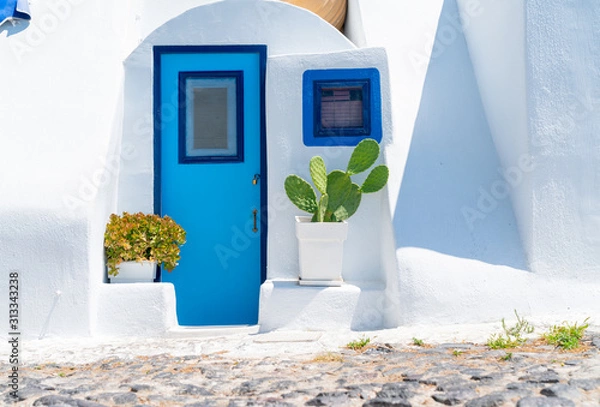 Fototapeta White exterior Mediterranean style entrance with blue door