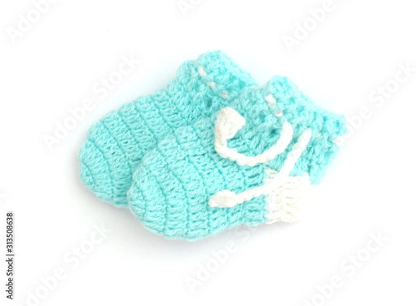 Fototapeta Handmade sweet baby booties isolated on a white background