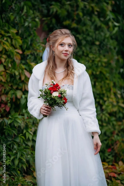 Fototapeta Young beautiful bride in a wedding dress