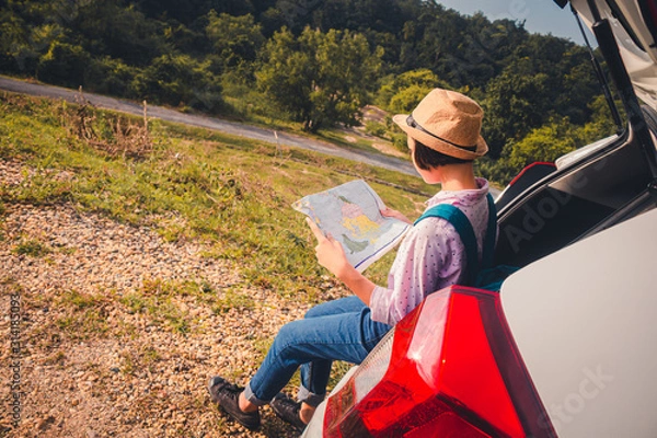 Fototapeta Female travelers travel with cars in the midst of peaceful nature, Traveling of tourists only to find the beauty of nature.