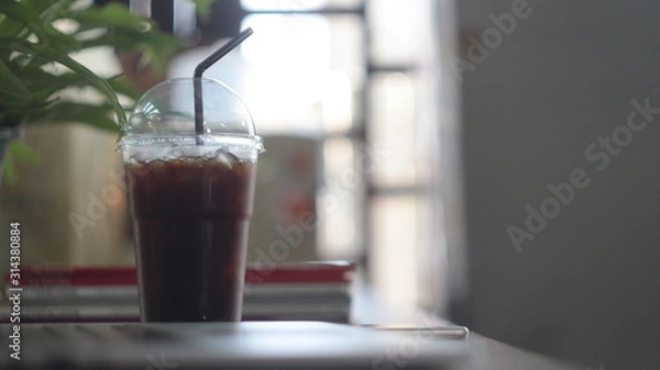 Fototapeta cup of coffee on wooden table