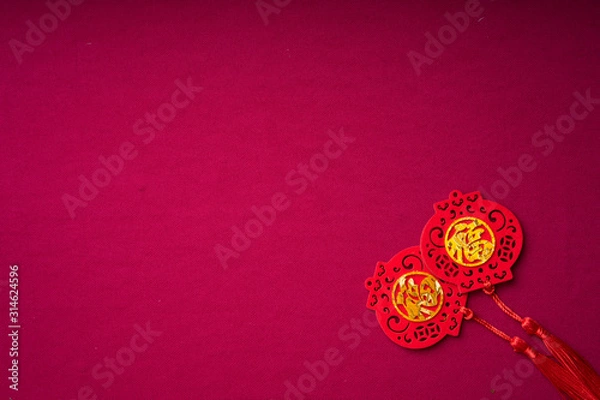 Fototapeta Chinese New Year decorations with red background with assorted festival decorations. Chinese characters means abundant of wealth, prosperity and luck. Flat lay.