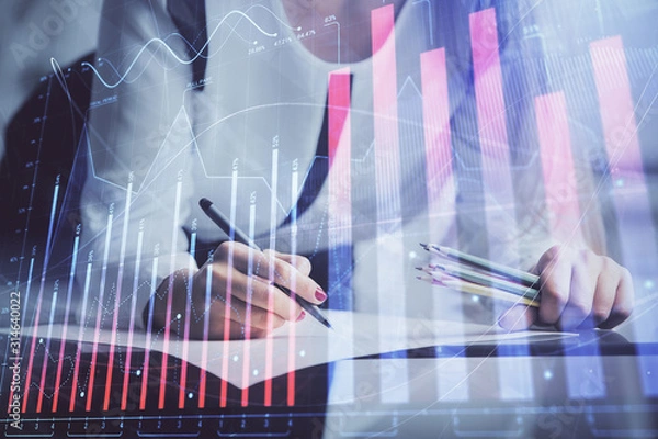 Fototapeta Double exposure of hands making notes with forex chart huds. Stock market concept.